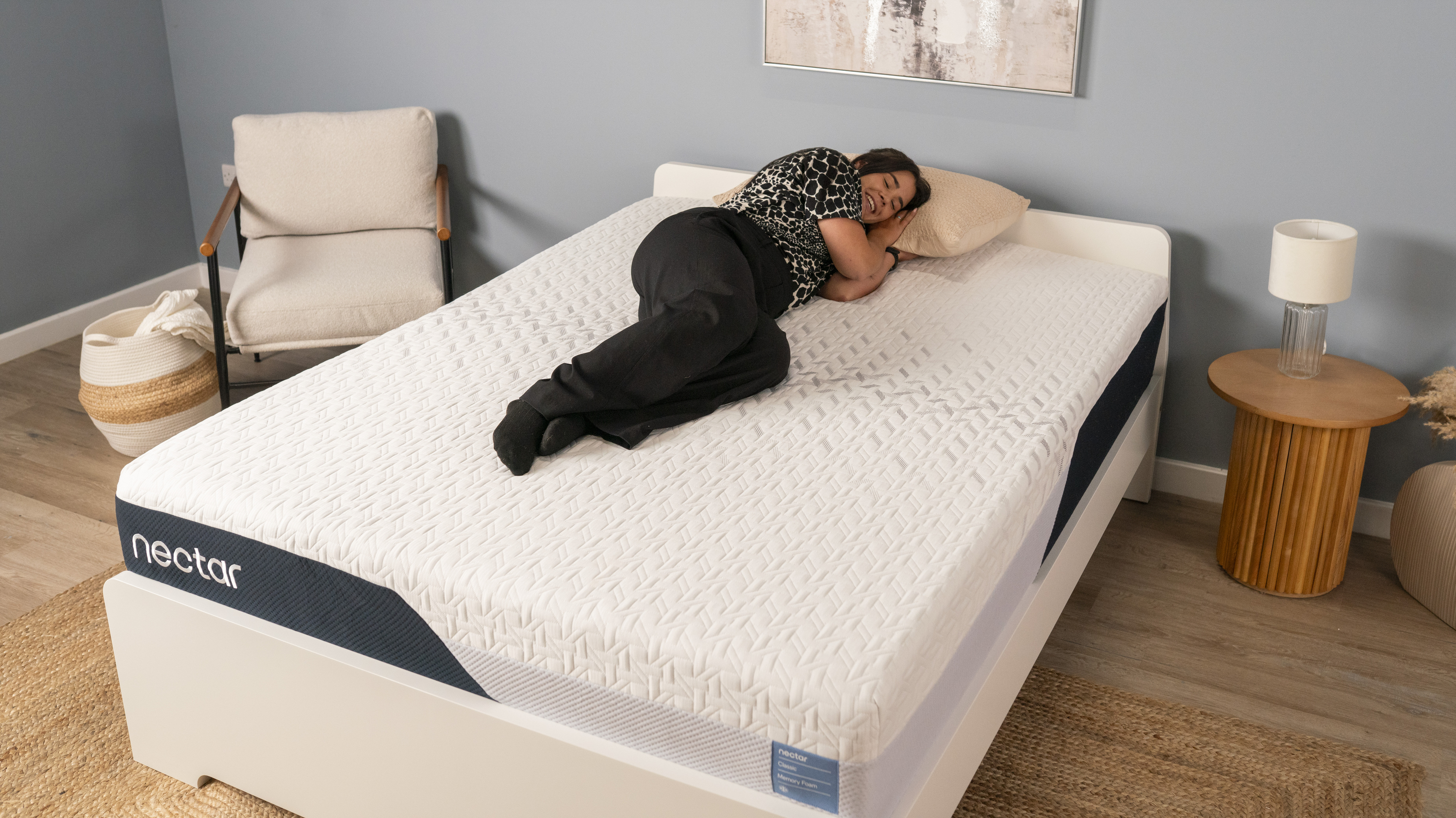 A member of Tom's Guide's testing panel sits on the edge of the Nectar Classic Memory Foam Mattress