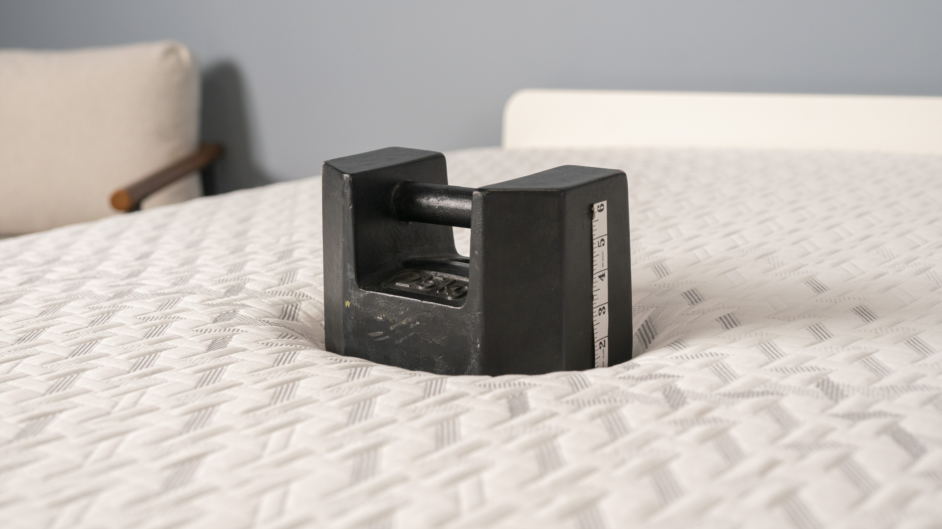 A weight is placed in the center of the Nectar Classic Memory Foam Mattress to measure pressure relief