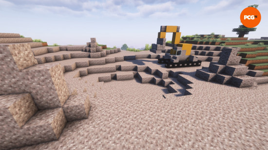 Best Minecraft builds: A yellow and gray digger on a large pit of gravel.