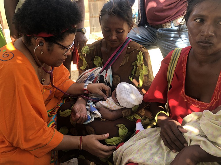 Iliana Curiel providing care to a newborn baby